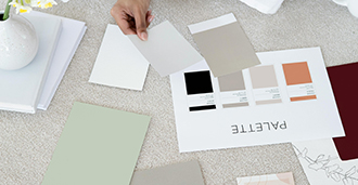 Individual out of frame pulling color swatches as they build a brand color palette.
