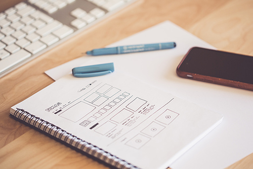 Sketch pad with website wireframes drawn out